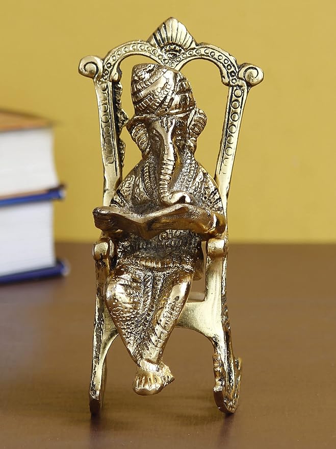 eCraftIndia Golden Metal Lord Ganesha Idol Reading Book On Rocking Chair - Decorative Hindu God Statue for Home Decor - Gift for Diwali, Housewarming - Ideal for Living Room, Office, Study Areas